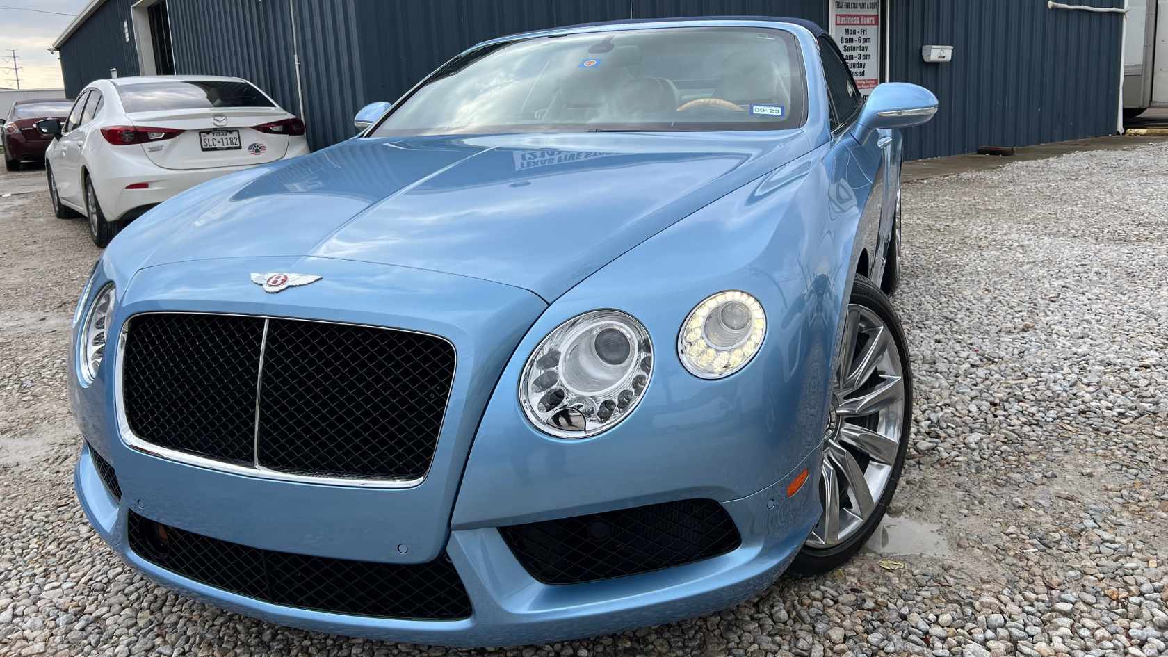 Flawless black custom paint job on a luxury sedan after auto body work in Garland, TX.
