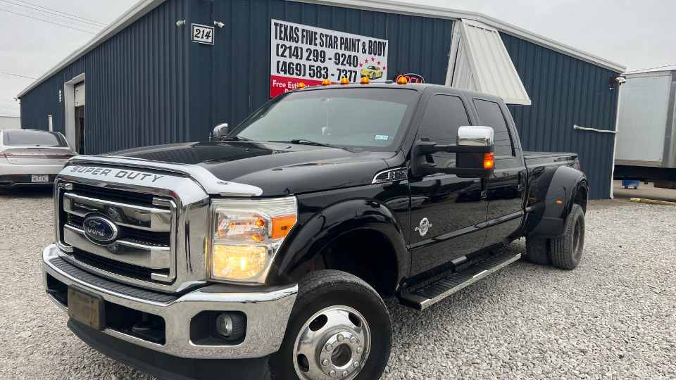 Before repair: Dented truck bed and scraped tailgate panels needing structural repair